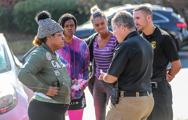 November 2021 DeKalb County: Deonna Bray (left) speaks with Clarkston Police Chief Christine Hudson (2nd from right) about news on Bray's missing son, 1-year old Blaise Barnett, who was taken when the car he was in was stolen while his parents were unloaded groceries. The baby was found 36 hours later when a neighbor found him in a car about a mile from where abduction occurred. (John Spink / John.Spink@ajc.com)


