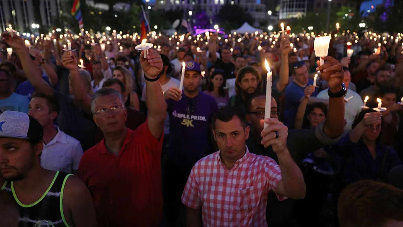 ORLANDO, FL - JUNE 13:  People hold candles during a memorial service at the Dr. Phillips Center for the Performing Arts for the victims of the Pulse gay nightclub shooting where Omar Mateen allegedly killed 49 people, June 13, 2016 in Orlando, Florida. The mass shooting killed at least 49 people and injuring 53 others in what is the deadliest mass shooting in the country's history.  (Photo by Joe Raedle/Getty Images)