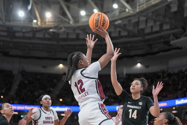 South Carolina guard MiLaysia Fulwiley (12) shoots over Vanderbilt forward Aiyana Mitchell (14) during an NCAA college basketball game in the quarterfinals of the Southeastern Conference tournament, Friday, March 7, 2025, in Greenville, S.C. (AP Photo/David Yeazell)