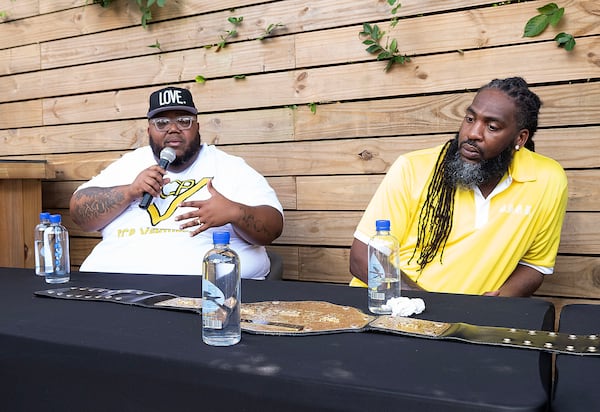 July 13, 2020, Atlanta — Lorenzo Lewis, left, talks at a meeting organized by "The Confess Project." Lewis includes hip-hop artists like Atlanta's Pastor Troy, right, on community conversations about men's mental health. The organization, founded by Lewis, enlists barbershops like Privado to double as mental health centers, where Black men can comfortably talk about their issues. (RYON HORNE/RHORNE@AJC.COM)