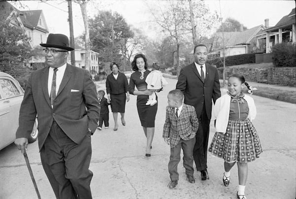 In 1964, the Rev. Martin Luther King Jr. takes a Sunday family walk in Atlanta with his father the Rev. Martin Luther King Sr., son Dexter, mother Alberta King, wife Coretta Scott King holding daughter Bernice, son Martin Luther King III and daughter Yolanda. Copyright by Max Scheler Estate, Hamburg Germany.