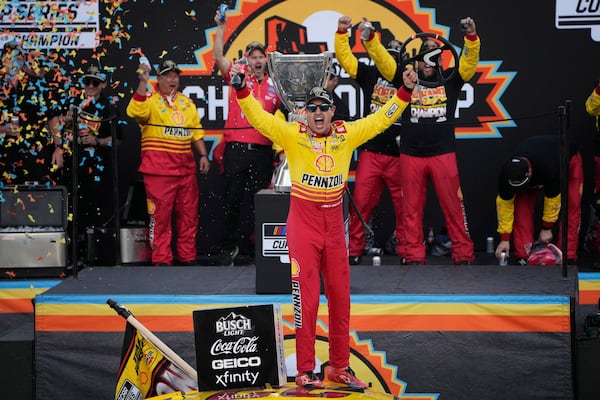 Joey Logano celebrates after winning a NASCAR Cup Series Championship auto race for the championship at Phoenix Raceway, Sunday, Nov. 10, 2024, in Avondale, Ariz. (AP Photo/John Locher)