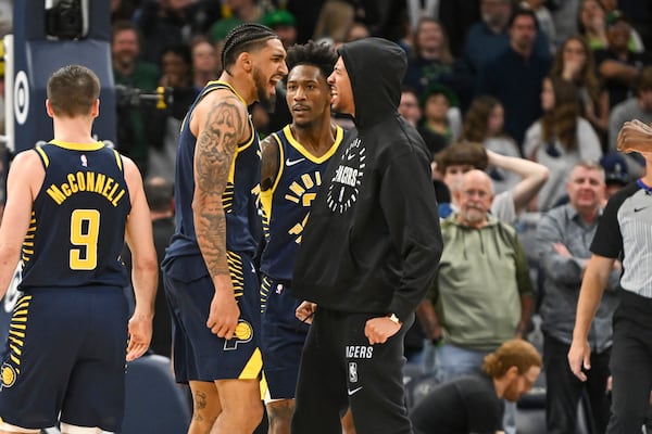 Indiana Pacers forward Obi Toppin, second from left, celebrates with guard Quenton Jackson, third from left, and guard Tyrese Haliburton, right, after scoring the winning 3-point basket to defeat the Minnesota Timberwolves in an NBA basketball game Monday, March 17, 2025, in Minneapolis. (AP Photo/Craig Lassig)