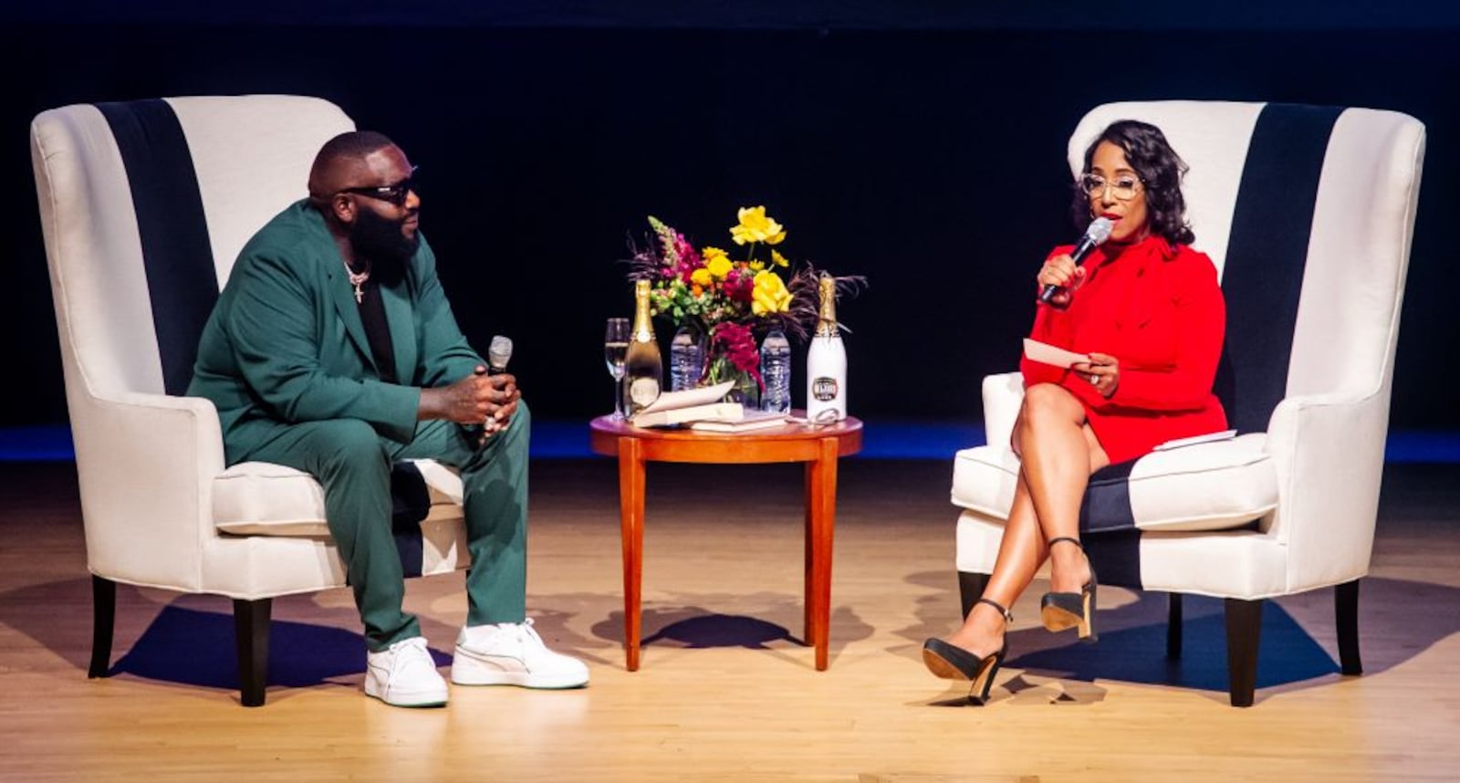 (l. to r.) Rapper Rick Ross joins law professor Moraima "Mo" Ivory at Rialto Center for the Arts on Nov. 7, 2023 in Atlanta.