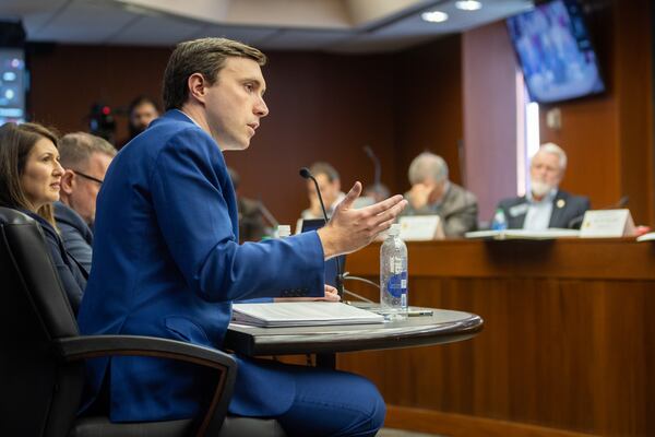 State Elections Director Blake Evans (left), spoke to the Senate Ethics Committee in Atlanta in 2023. He defended Georgia's participation in the voter registration accuracy organization called ERIC on Tuesday.