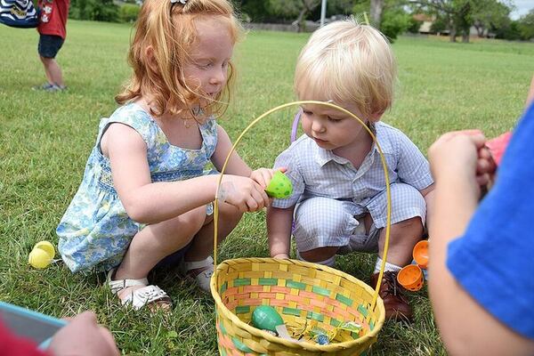 Hazel and Charlie Garrett check out the prizes in the gathered eggs after the hunt.