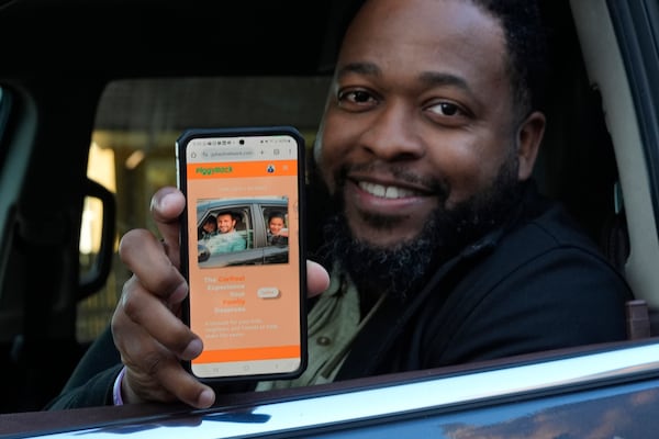 PiggyBack Network, co-founder and CEO Ismael El-Amin sits in his car for a portrait with the PiggyBack ride-share App Friday, Oct. 18, 2024, in Chicago. (AP Photo/Charles Rex Arbogast)