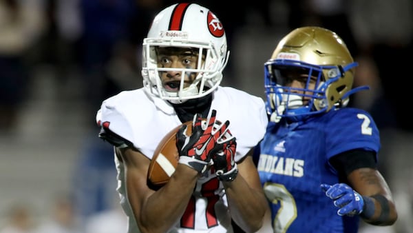 North Gwinnett wide receiver Josh Downs (11) catches a pass against McEachern defensive back Dacari Collins (2) in the first half during the Class AAAAAAA quarterfinals Nov. 29, 2019, at McEachern High School  in Powder Springs.