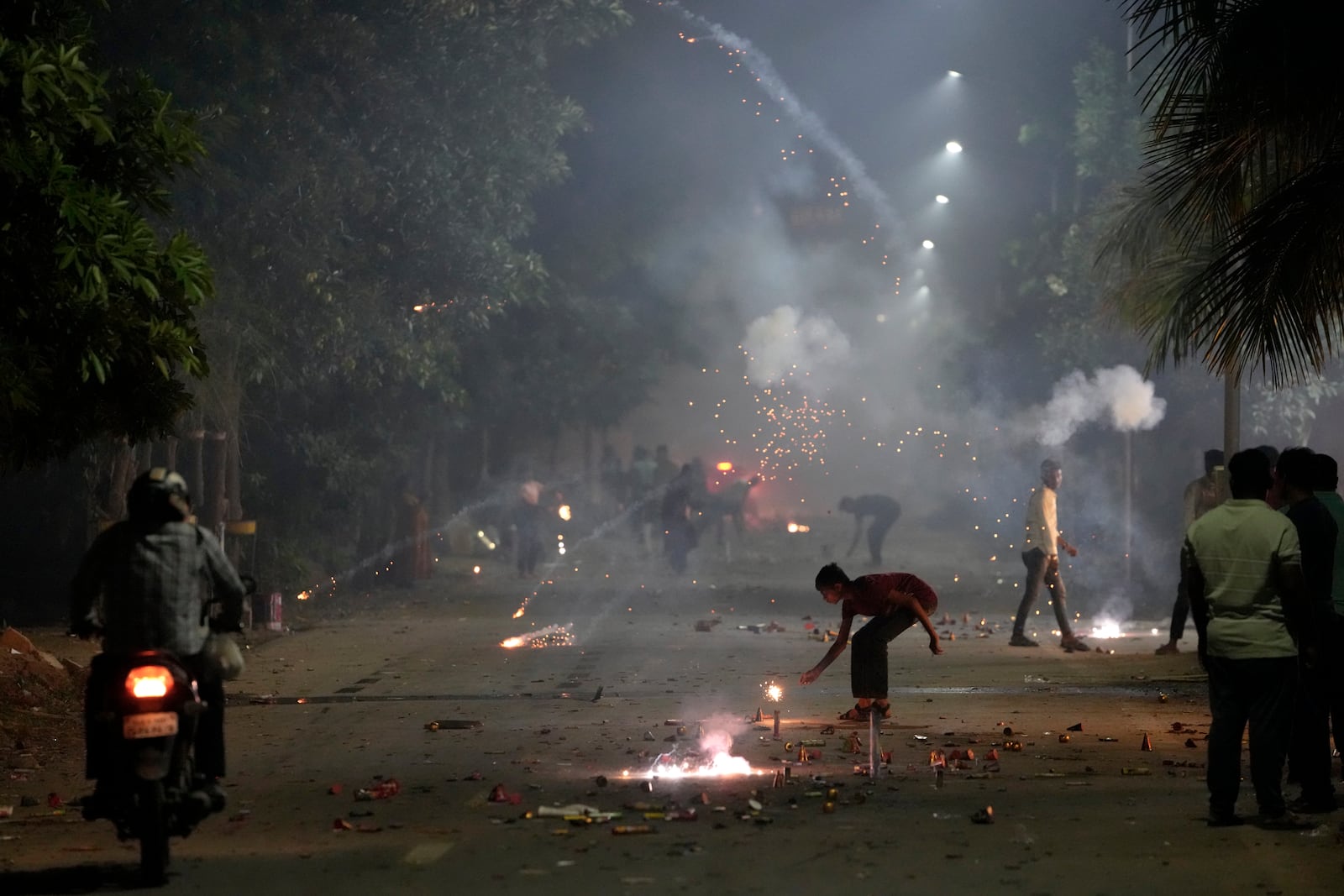 FILE- People lights firecrackers to celebrate Diwali, the festival of lights, in Ahmedabad, India, Oct. 24, 2022. (AP Photo/Ajit Solanki, File)