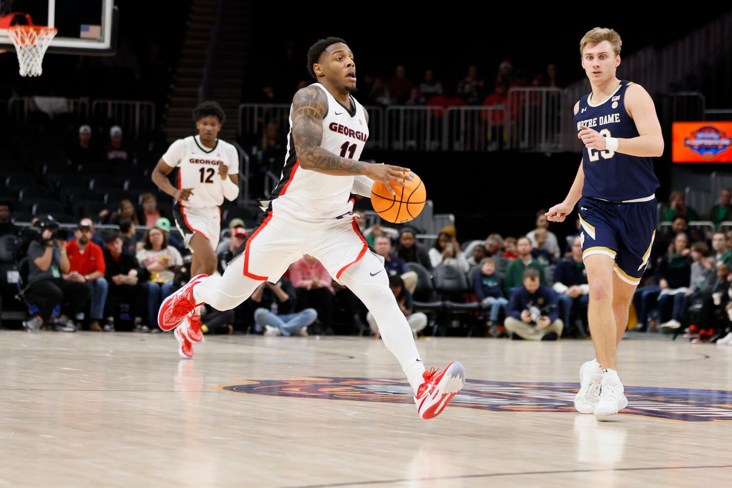 Bulldogs guard Justin Hill drives as Fighting Irish guard Dane Goodwin defends during the second half Sunday night at State Farm Arena. (Miguel Martinez / miguel.martinezjimenez@ajc.com)