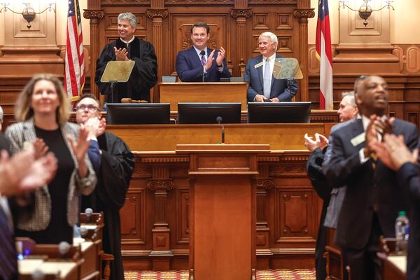 (Left to right) Georgia Supreme Court Chief Justice Michael P. Boggs, Lt. Gov. Burt Jones and House Speaker Jon Burns clap before the annual State of the Judiciary address on Feb. 7, 2024.