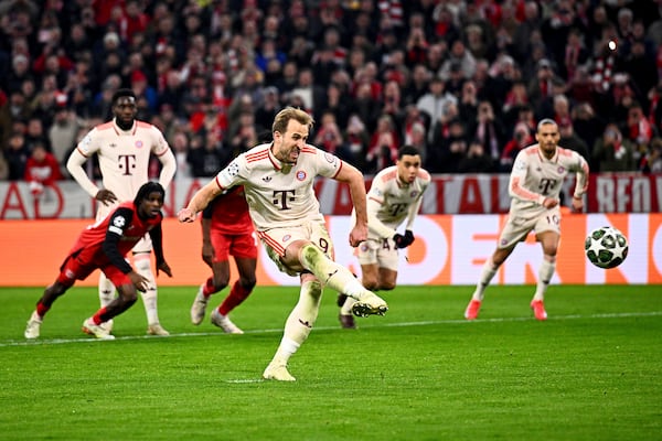 Munich's Harry Kane scores his side's third goal during the Champions League round of 16 first leg soccer match between FC Bayern Munich and Bayer 04 Leverkusen in Munich, Germany, Wednesday, March 5, 2025. (Tom Weller/dpa via AP)