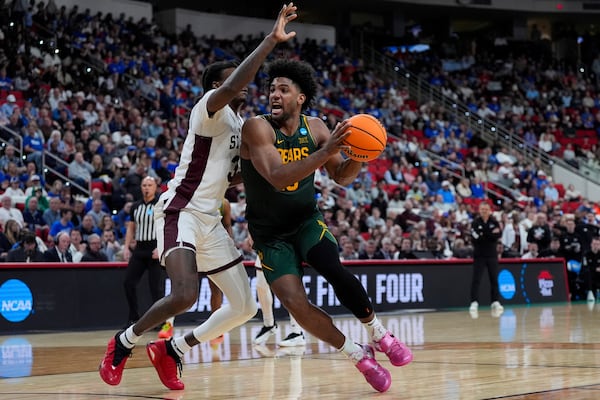 Baylor forward Norchad Omier (15) drives toward the basket past Mississippi State forward KeShawn Murphy (3) during the second half in the first round of the NCAA college basketball tournament, Friday, March 21, 2025, in Raleigh, N.C. (AP Photo/Stephanie Scarbrough)