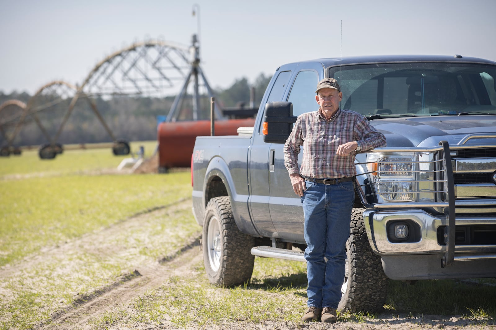 Ray Davis, a Bulloch County farmer, stands near one of his wells and pivots that irrigate part of his 1,100 acres on Wednesday, Feb. 21, 2024, in Brooklet, Ga. Davis is concerned plans to pump groundwater to supply Hyundai's Metaplant EV factory will compromise local freshwater wells, and saddle taxpayers with higher water rates to pay for the project. Davis is now a county commissioner-elect in Bulloch. (Stephen B. Morton for the AJC)
