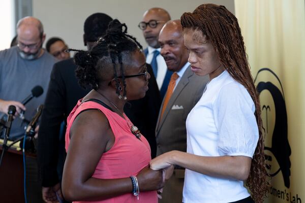 Wanda Garneaux (left) talks with Secoriea Turner’s mother Charmaine after the announcement of a scholarship in the slain child's name.