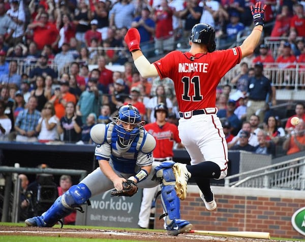 Ender Inciarte of the Braves scores a second-inning run in Friday's loss to the Dodgers, but was hurt on the play. (Photo by Scott Cunningham/Getty Images)