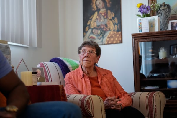 Sister JoAnn Persch, 90, a nun with the Sisters of Mercy, listens to Oscar, an immigrant from Central America seeking asylum, at her home Thursday, Feb. 20, 2025, in Alsip, Ill. (AP Photo/Erin Hooley)