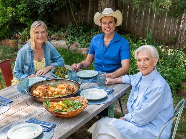 Kimbal Musk sits in front of recipes from his book "The Kitchen Cookbook" with his sister Tosca Musk (L) and mother Maye Musk (R).