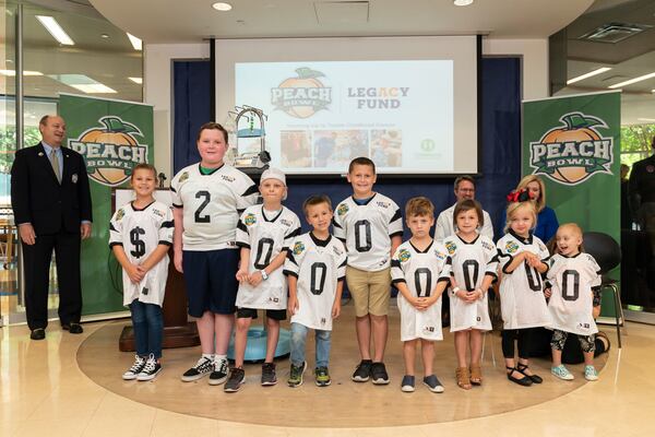 Peach Bowl Inc. CEO and President, Gary Stokan, (L) smiles as the Peach Bowl's historic donation to Children's Healthcare of Atlanta is revealed. The $20 million commitment will establish the Peach Bowl LegACy fund to fight childhood cancer. (Paul Abell via Abell Images for Peach Bowl)