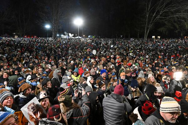 The crowd watches the festivities while waiting for Punxsutawney Phil, the weather prognosticating groundhog, to come out and make his prediction during the 139th celebration of Groundhog Day on Gobbler's Knob in Punxsutawney, Pa., Sunday, Feb. 2, 2025. (AP Photo/Barry Reeger)