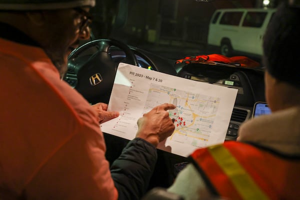 Jose Sandoval, the director of homeless at Frontline Response Atlanta, looks over the map of locations they’ll visit to participate in the PIT, (Point-In-Time) count at St. Luke’s Episcopal Church, Monday, Jan. 23, 2023, in Atlanta. The group of volunteers and staff from supporting agencies where participating in the PIT count, a practice mandated by the federal government that tallies people who were homeless on one night in January of each year. Jason Getz / Jason.Getz@ajc.com)
