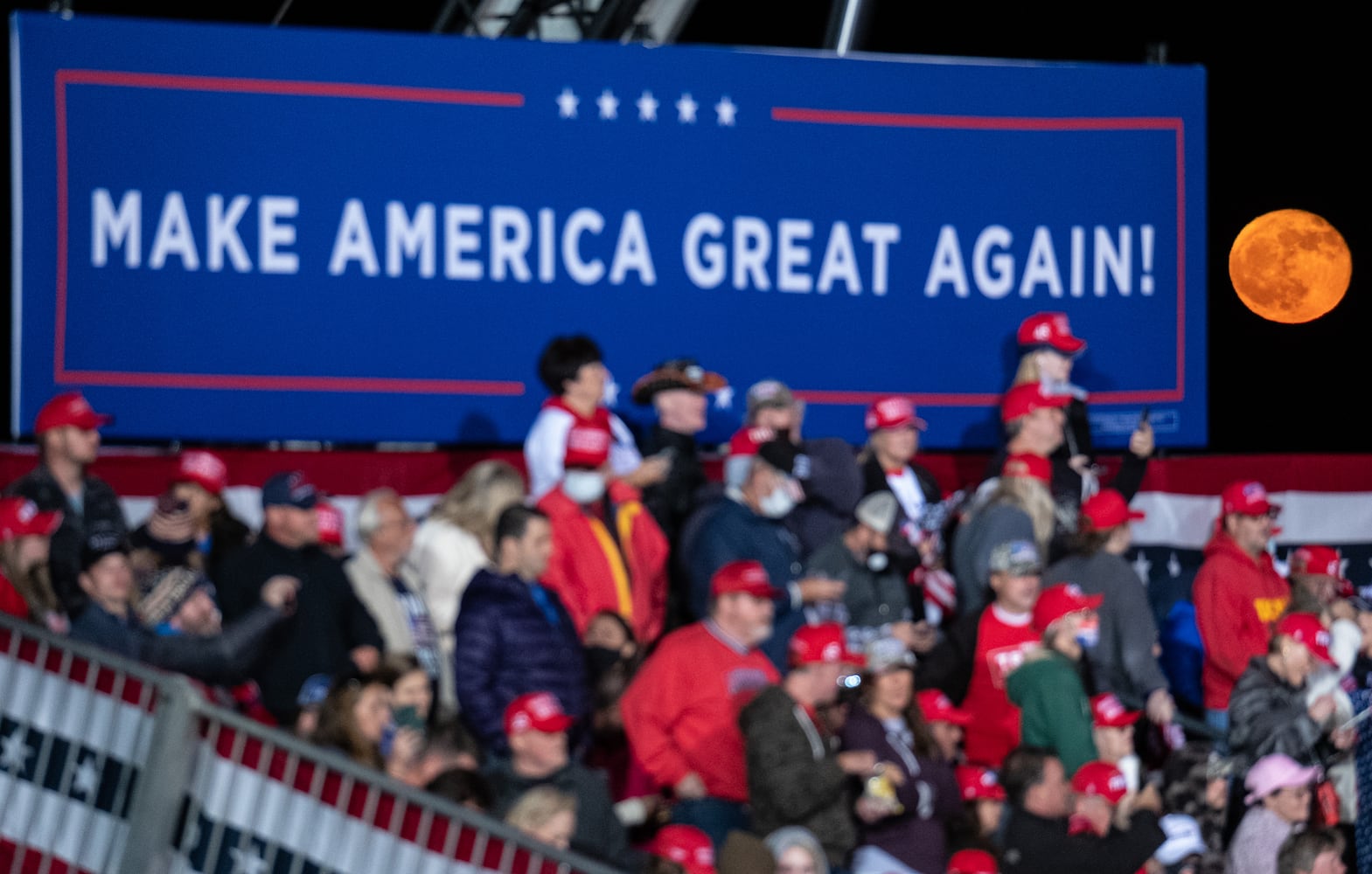 The moon rises behind supporters before the beginning of a Trump rally at Richard B. Russell Airport in Rome on Sunday evening, Nov. 1, 2020. (Photo: Ben Gray for The Atlanta Journal-Constitution)