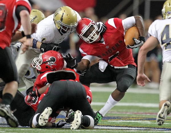 121011 Atlanta, Ga; Landmark Christian defensive back Donald Payne (1, left) tackles Savannah Christian running back Jalen Myrick (5) for a short gain in the first half of the Class A Georgia State High School Football Championship at the Georgia Dome Saturday afternoon in Atlanta, Ga., December 10, 2011. Savannah Christian lead Landmark Christian 7-3 at the end of the first half. Landmark Christian is in the final for the first time in school history. Jason Getz jgetz@ajc.com