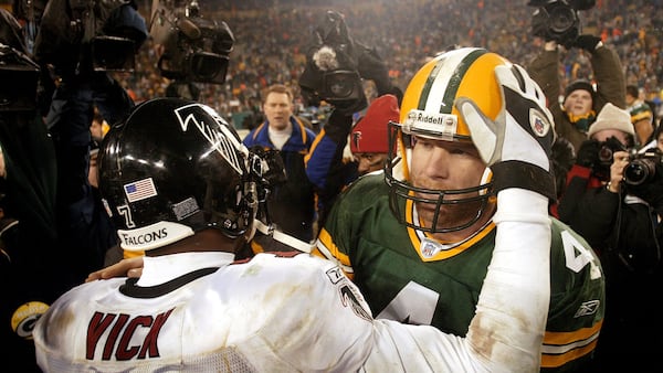 Atlanta Falcons' quarterback Michael Vick (7) embraces Green Bay Packers' quarterback Brett Favre following their NFC Wildcard game Saturday, Jan. 4, 2003, in Green Bay, Wis. The Falcons won 27-7.