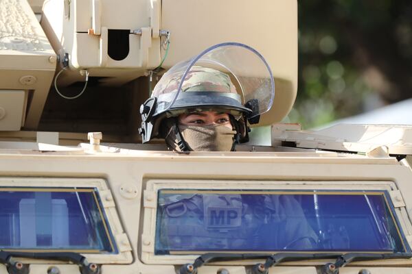 1/17/21 - Atlanta -   A National Guard MP keeps watch from an armored security vehicle at the state Capitol. Armed militias planned to protest the election of President-Elect Joe Biden ahead of Wednesday's inauguration. This is part of a national call-out for protests in all 50 state capital cities.  (Curtis Compton / Curtis.Compton@ajc.com)