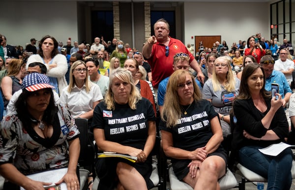 Ron Tripodo, center, yells at the Cherokee County School Board after they passed a resolution to ban teaching Critical Race Theory and then adjourned the meeting Thursday night, May 20, 2021 Tripodo was upset that the language in the resolution was ambiguous and didn’t really do anything. (Ben Gray for the Atlanta Journal-Constitution)