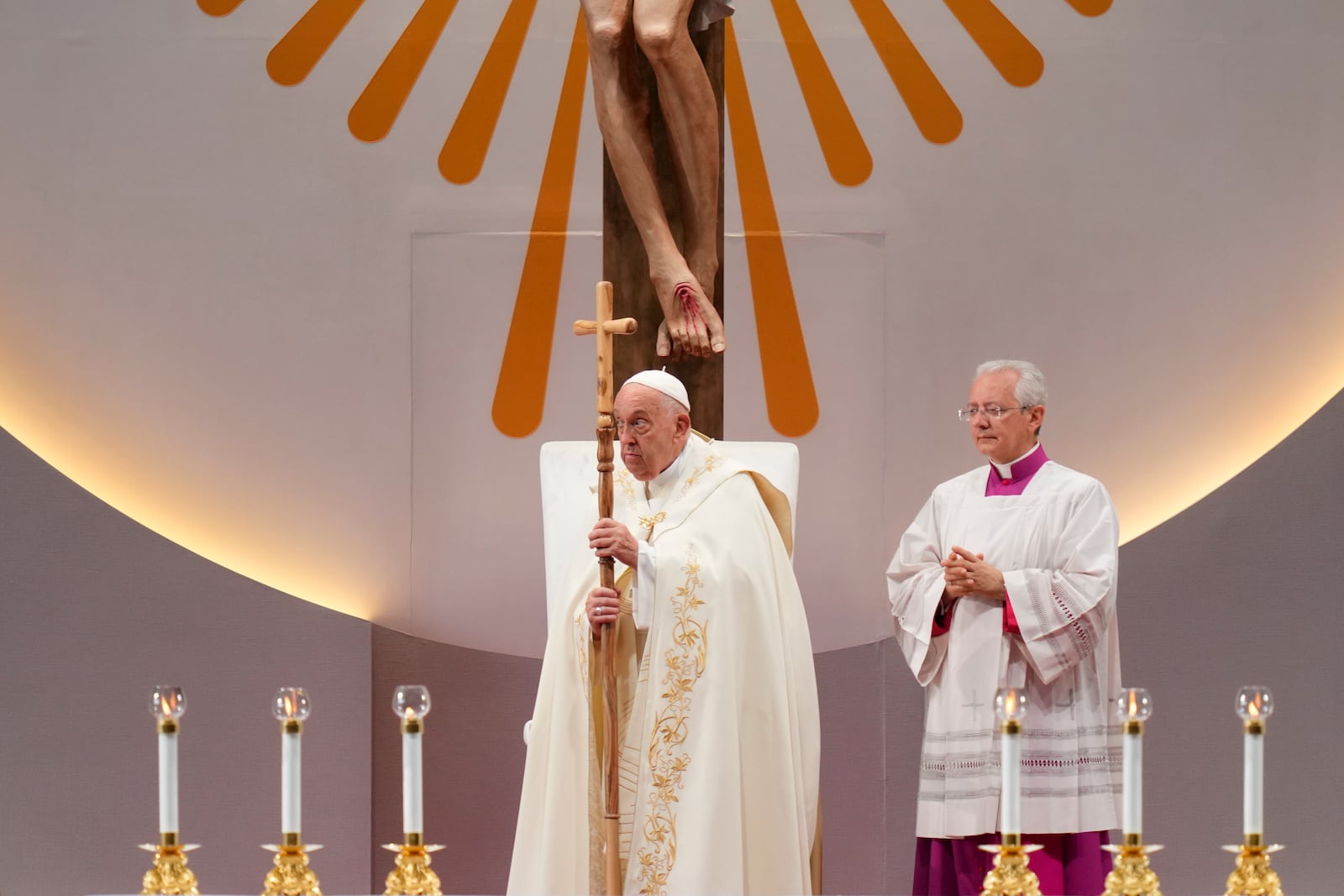 Pope Francis, left, leads a holy mass at the SportsHub National Stadium in Singapore, Thursday, Sept. 12, 2024. (AP Photo/Vincent Thian)