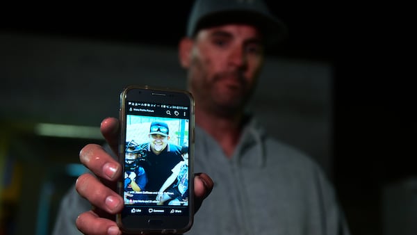 Jason Coffman displays a photo of his son Cody outside the Thousands Oaks Teene Center where he came hoping to find his son who was at the Borderline Bar and Grill in Thousand Oaks, California, on November 8, 2018. - Twelve people, including a police sergeant, were shot dead in a shooting at the bar close to Los Angeles, police said Thursday. All the victims were killed inside the bar in the suburb of Thousand Oaks late on November 7, including the officer who had been called to the scene, Sheriff Geoff Dean told reporters. The gunman was also dead at the scene, Dean added.