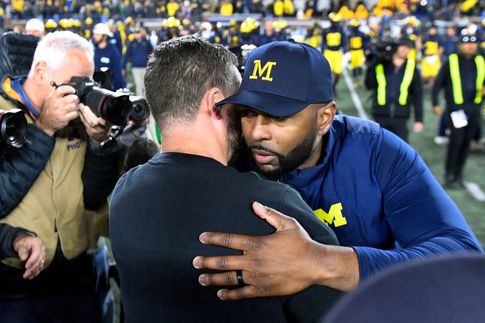 Oregon head coach Dan Lanning, left, greets Michigan head coach Sherrone Moore following an NCAA college football game, Saturday, Nov. 2, 2024, in Ann Arbor, Mich. Oregon defeated Michigan 38-17. (AP Photo/Jose Juarez)