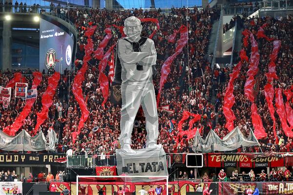 Atlanta United fans raise an image of head coach Gerardo “Tata” Martino to start the game against New York City during the first half in their MLS Eastern Conference Semifinal playoff match on Sunday, Nov. 11 in Atlanta. Curtis Compton/ccompton@ajc.com