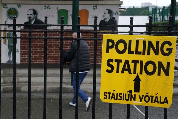 People arrive to cast their votes at the polling station at St Laurence O'Tooles National School in Dublin, Friday Nov. 29, 2024, as voters go to the polls in the 2024 General Election in Ireland. (Brian Lawless/PA via AP)