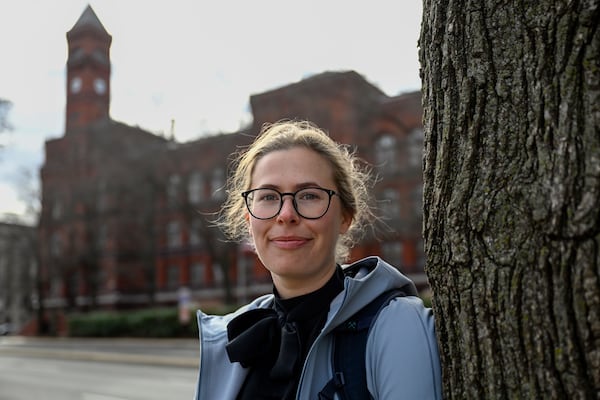 Sydney Smith, who lost her job due to DOGE cuts, stands in front of the Sydney Yates building that houses the Forest Service on Thursday, March. 6, 2025, in Washington. (AP Photo/John McDonnell)