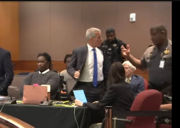 Brian Steel, attorney for rapper Young Thug, removes his suit jacket and tie before heading to a short stint in lockup after being found in contempt of court.