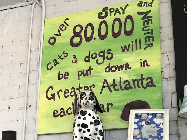 The Second Life Atlanta thrift store is decorated with pet art, some of which carries a message. CREDIT: SHELIA POOLE