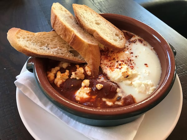 Huevos a la Flamenca at Bar Mercado has a sauce that, for a Spanish dish, is smokier and more heat-laden than expected. LIGAYA FIGUERAS / LFIGUERAS@AJC.COM