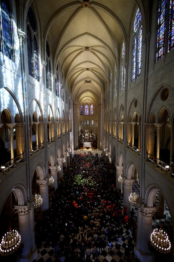 French President Emmanuel Macron delivers a speech to construction workers inside the Notre-Dame de Paris cathedral after visiting the restored interiors of the monument, Friday, Nov. 29, 2024 in Paris. (Sarah Meyssonnier/Pool via AP)