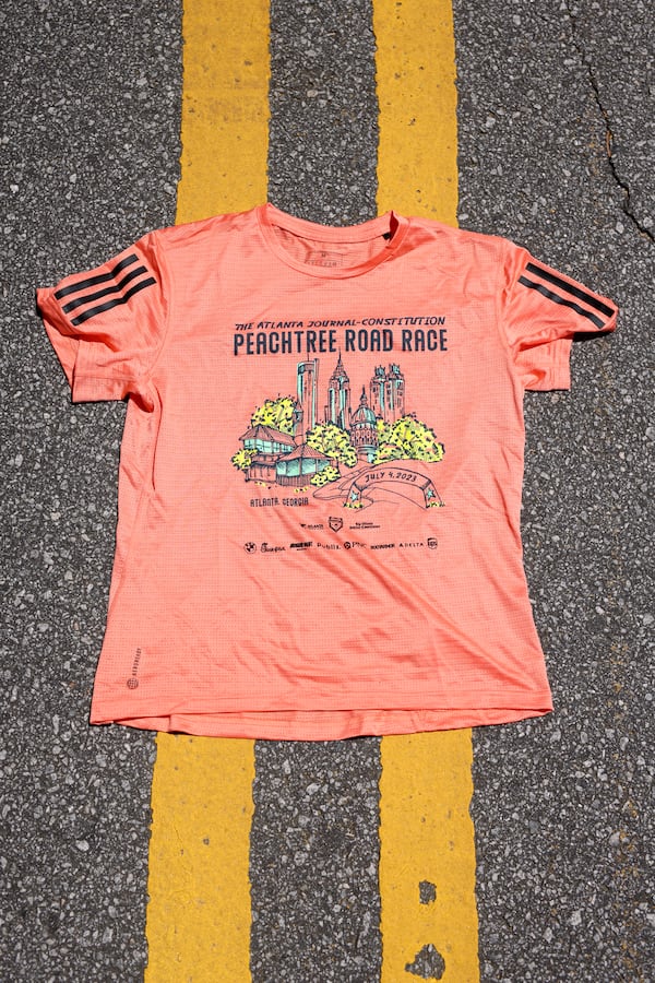 The Atlanta Journal-Constitution Peachtree Road Race 2023 t-shirt, shown at the Atlanta Track Club, Tuesday, June, 27, 2023. (Jason Getz / Jason.Getz@ajc.com)