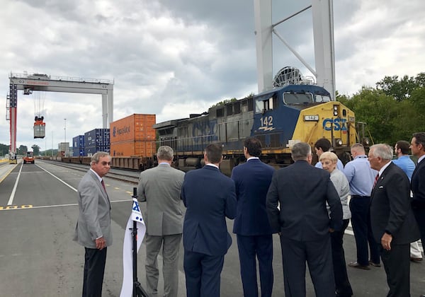 Dignitaries, including Gov. Nathan Deal, right, watch the hoisting of the ceremonial first container from a train onto a truck at the Appalachian Regional Port in Crandall, Ga., on Wednesday August 22, 2018. The Georgia Ports Authority’s new inland port is expected to handle 50,000 containers a year and potentially double that capacity in the next 10 years. J. SCOTT TRUBEY/STRUBEY@AJC.COM