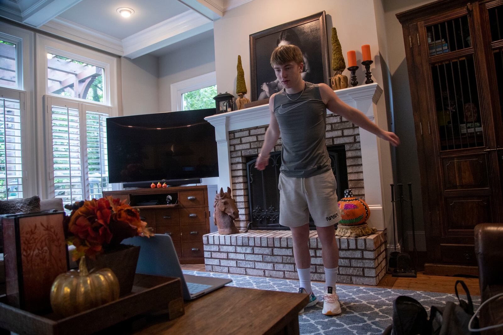 Howard Middle School eighth grader Jack Jenkins participates in a physical education class in his living room in Atlanta on Friday, August 28, 2020. (Alyssa Pointer / Alyssa.Pointer@ajc.com)