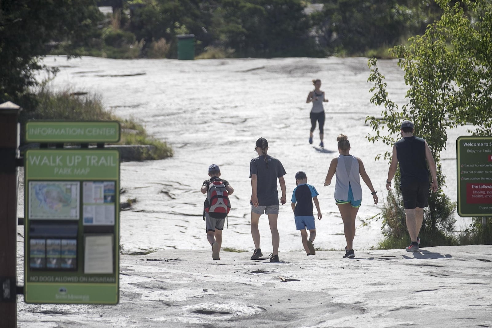 People prepare the trek up Stone Mountain. (ALYSSA POINTER/ALYSSA.POINTER@AJC.COM)