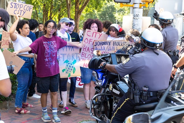 Protestors against Atlanta’s planned public safety training center, known by some as “Cop City,” gather at Fulton County Courthouse in Atlanta on Monday, August 14, 2023, as Fulton prosecutors present a their election interference case against former President Donald Trump and others to a grand. (Arvin Temkar / arvin.temkar@ajc.com)