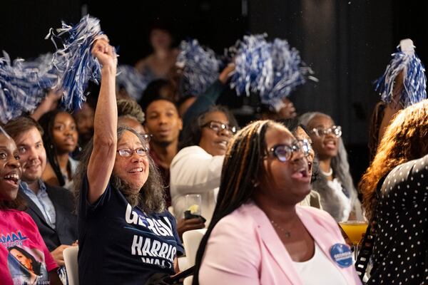 People cheer while watching the final night of the Democratic National Convention during a party at The Gathering Spot in Atlanta on Thursday.