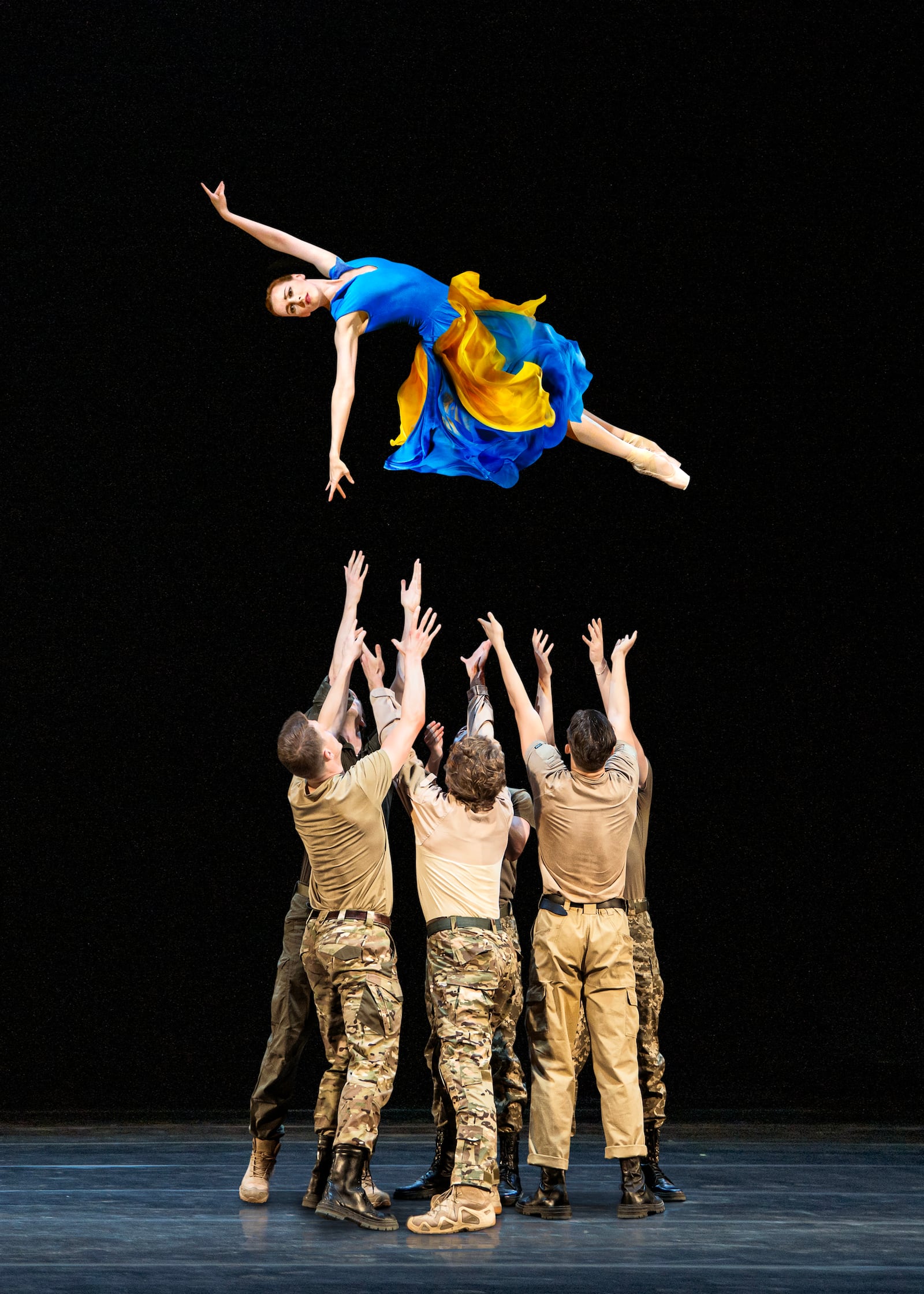 Tetiana Lozova, in the air, and National Ballet of Ukraine company members. Courtesy of Oleksandra Zlunitsyna.