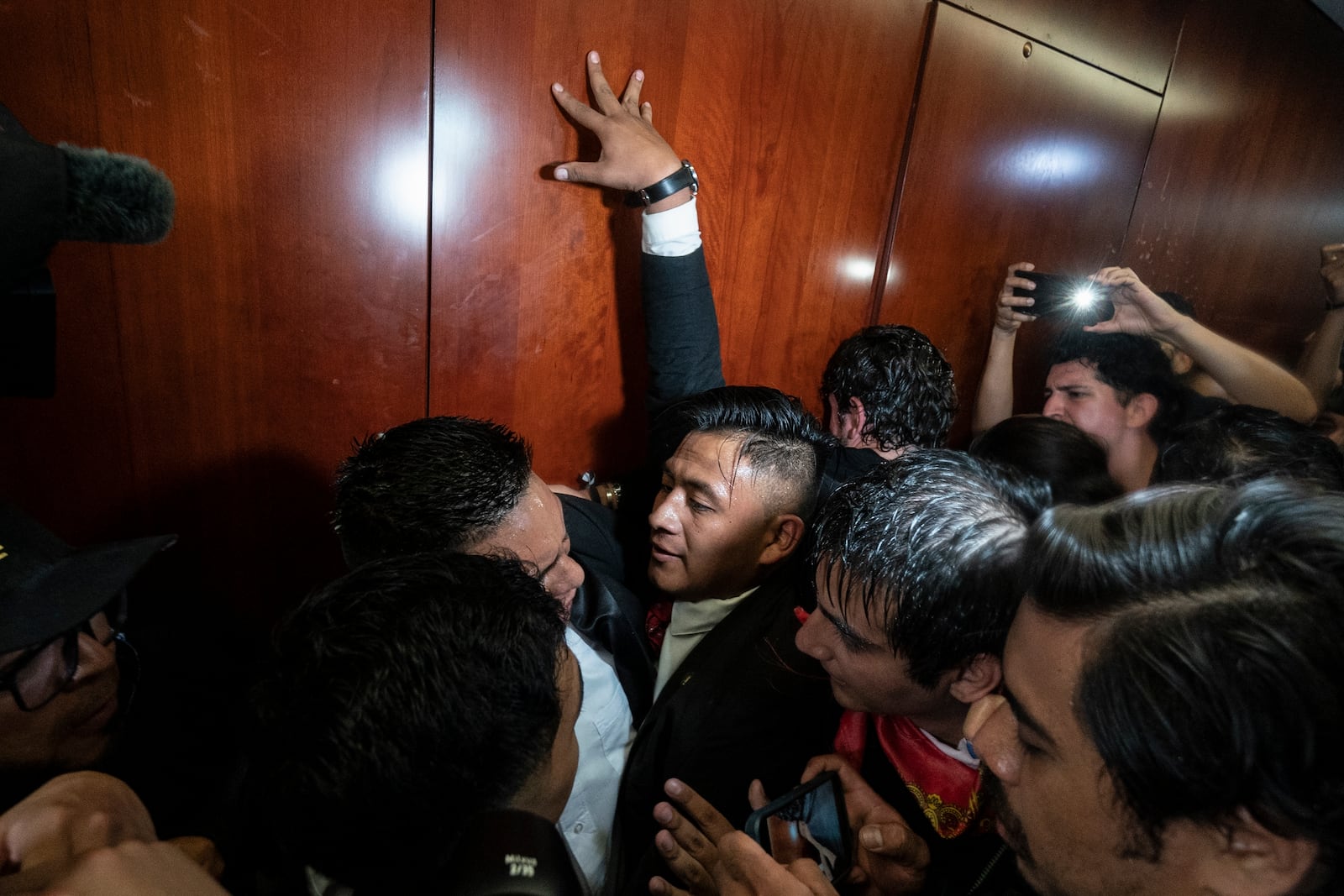 Protesters attempt to bypass a security guard and break into a Senate room, as lawmakers weigh the government's proposed judicial reform, which would make judges stand for election, in Mexico City, Tuesday, Sept. 10, 2024. (AP Photo/Felix Marquez)