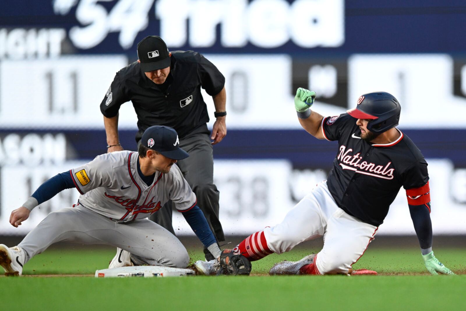 Atlanta Braves second baseman Cavan Biggio, left, tags out Washington Nationals' Juan Yepez attempting a double during the second inning of a baseball game, Wednesday, Sept. 11, 2024, in Washington. (AP Photo/John McDonnell)