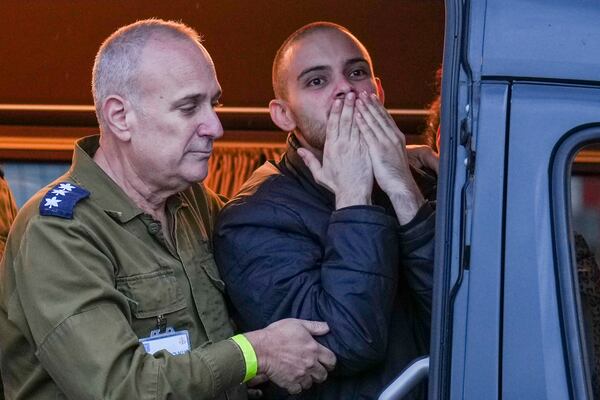 Freed Israeli hostage Omer Wenkert, gestures from a van as he arrives at Beilinson hospital in Petah Tikva, Israel, after he was released from Hamas captivity in the Gaza Strip, Saturday, Feb. 22, 2025. (AP Photo/Ariel Schalit)